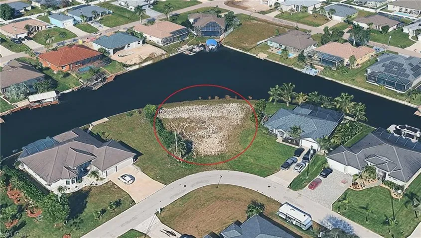 Aerial view of residential area featuring a nearby body of water