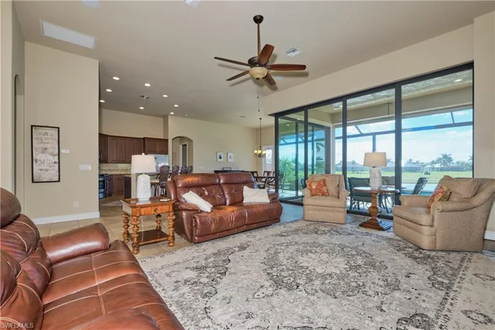 Tiled living room featuring ceiling fan