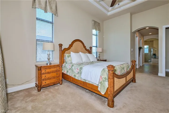 Carpeted bedroom with ceiling fan