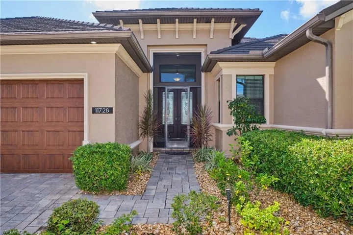 View of exterior entry with a garage