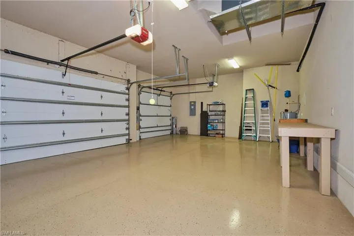 Garage with a garage door opener and electric panel