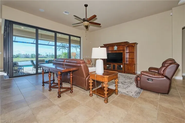 Tiled living room featuring ceiling fan