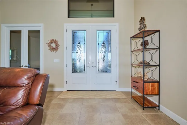 Foyer entrance featuring french doors and light tile patterned floors