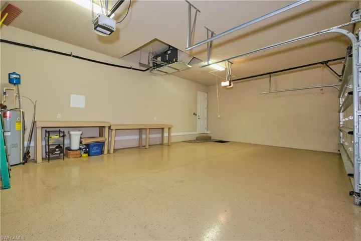 Garage with electric water heater and a garage door opener