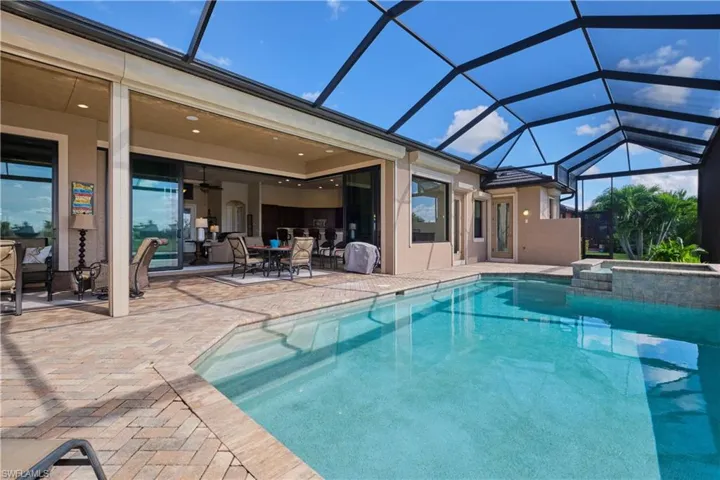 View of swimming pool featuring a patio, a lanai, and ceiling fan