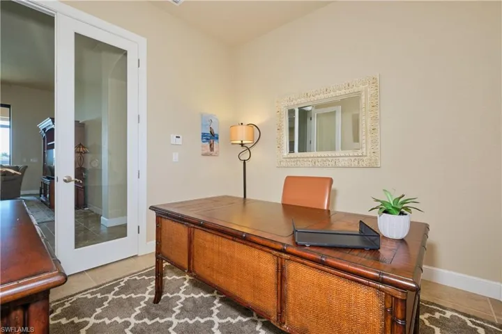 Office with french doors and tile patterned floors