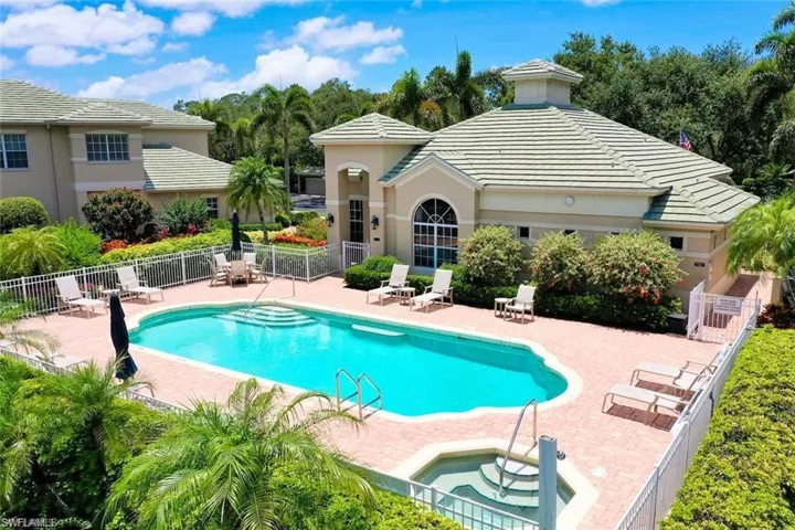 Community pool featuring a patio area and a community hot tub