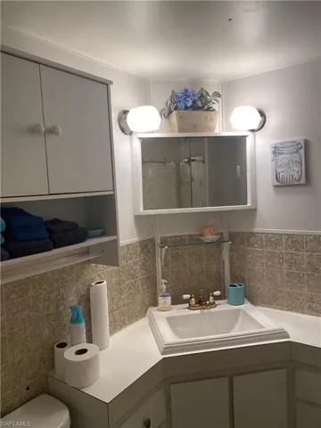 Bathroom vanity, and tile walls