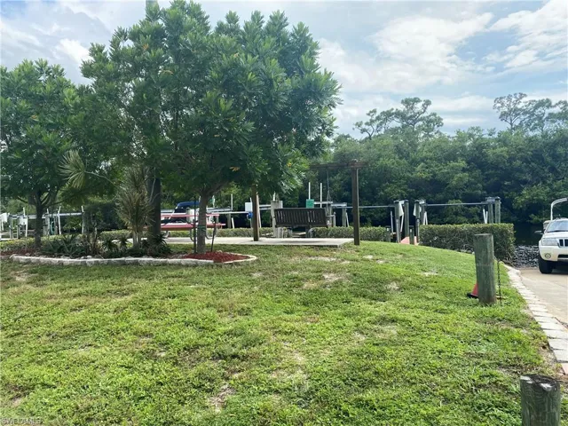 View of property's community with a lawn