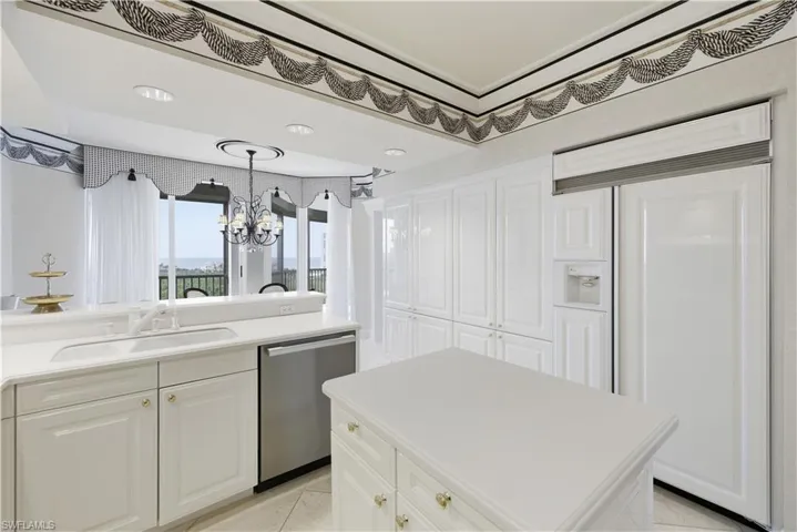 Carpeted living area with baseboards and crown molding