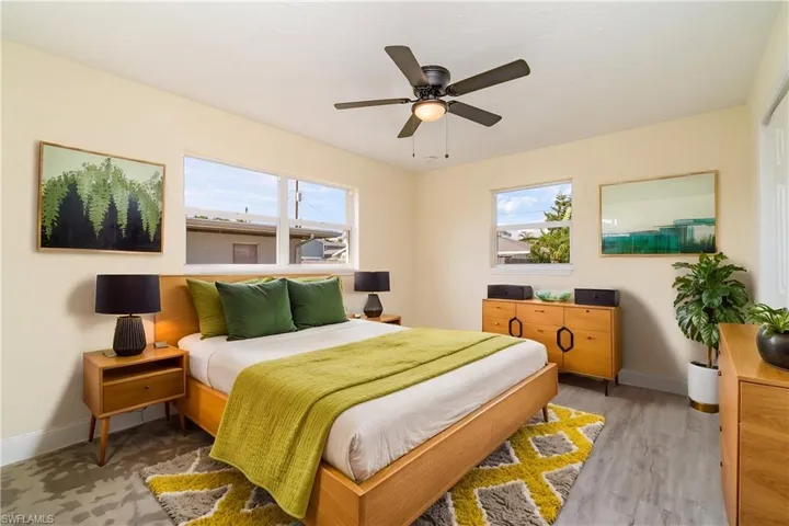 Bedroom with ceiling fan and light wood-style flooring