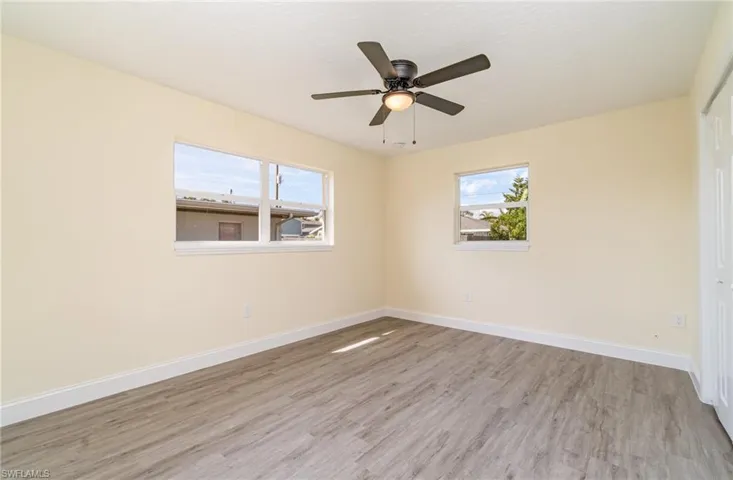 Unfurnished bedroom featuring a closet, light wood finished floors, and ceiling fan