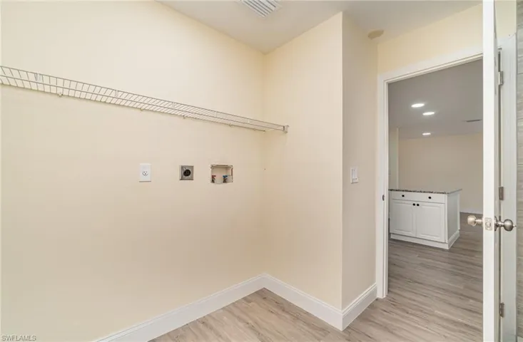 Laundry area with light wood-style floors, electric dryer hookup, washer hookup, and recessed lighting