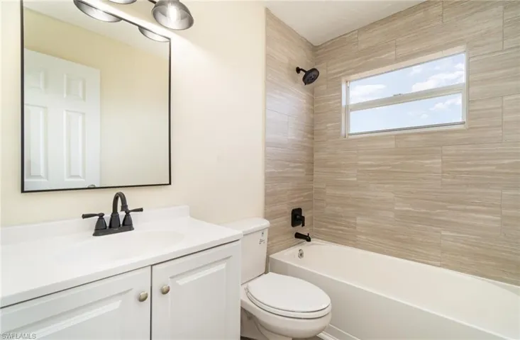 Full bath featuring shower / washtub combination and vanity