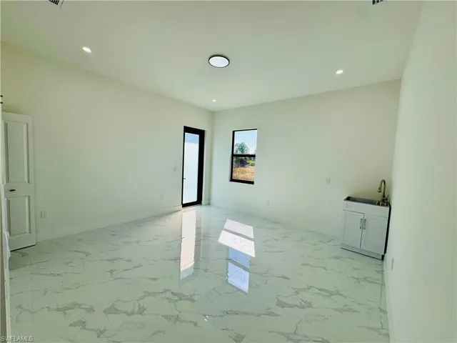 Unfurnished room featuring light marble finish floors and recessed lighting