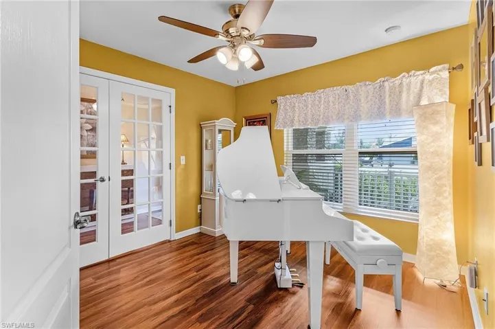Miscellaneous room featuring french doors, ceiling fan, and hardwood / wood-style flooring