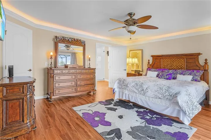 Bedroom featuring ornamental molding, ceiling fan, and light wood-type flooring