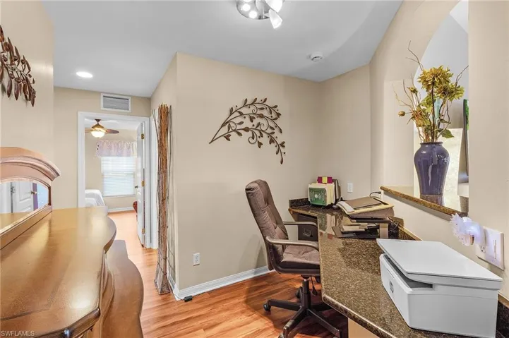 Office space featuring ceiling fan and light wood-type flooring