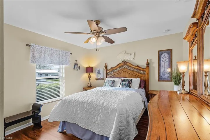 Bedroom featuring ceiling fan and dark hardwood / wood-style flooring