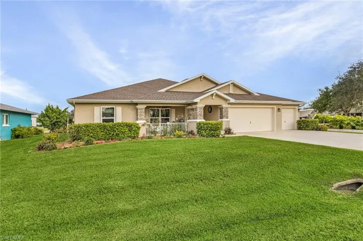 View of front of house featuring a garage, covered porch, and a front yard