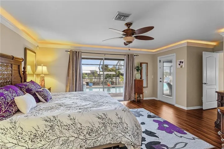 Bedroom featuring crown molding, dark hardwood / wood-style floors, access to outside, and ceiling fan