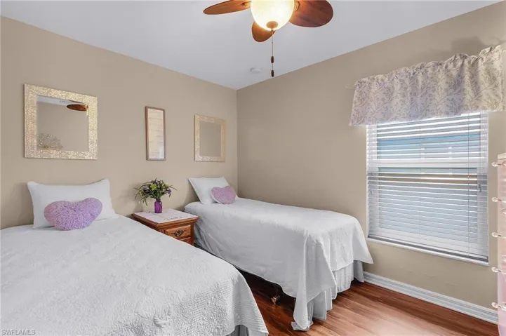 Bedroom featuring hardwood / wood-style floors and ceiling fan