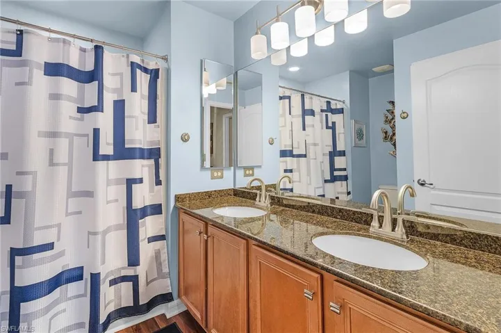 Bathroom featuring vanity and hardwood / wood-style floors