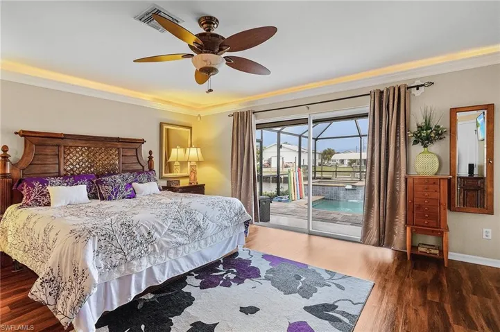 Bedroom featuring ornamental molding, hardwood / wood-style floors, access to exterior, and ceiling fan