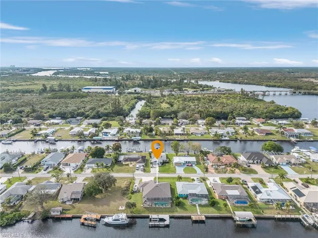 Birds eye view of property with a water view