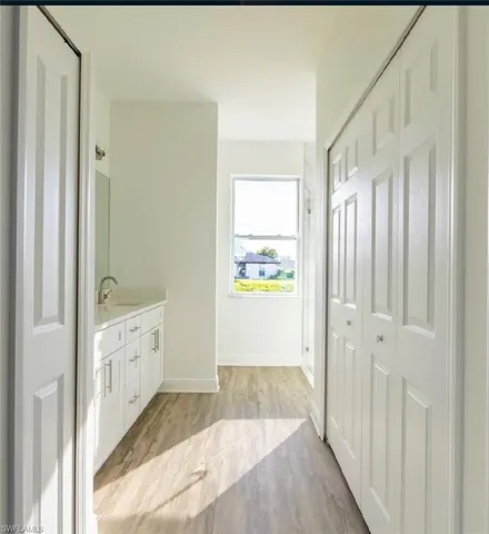 Bathroom with vanity and wood-type flooring
