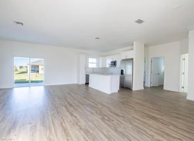 Unfurnished living room featuring light wood-type flooring