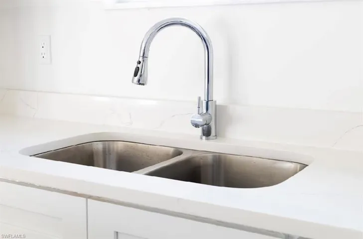 Room details with white cabinets and sink