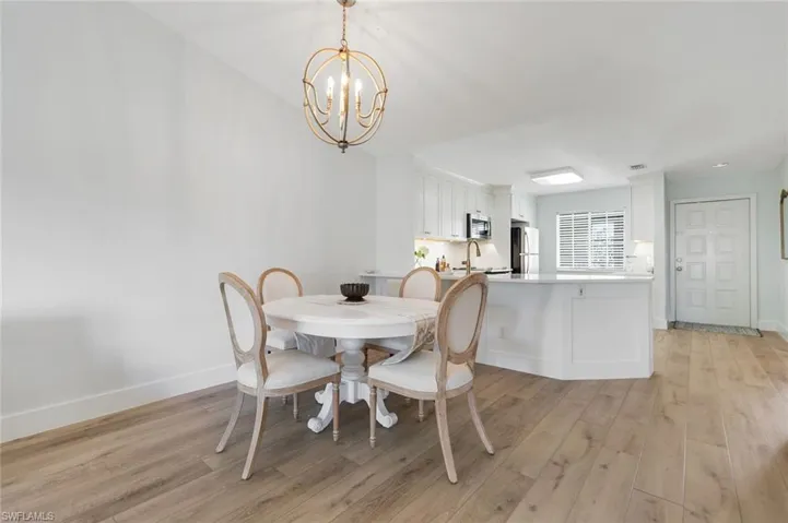 Dining space featuring light wood-style floors and a chandelier