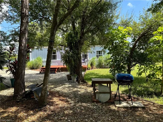 View of property's community with a lawn