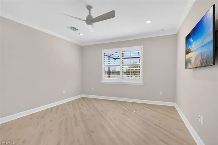 Unfurnished room with light wood finished floors, ornamental molding, recessed lighting, and ceiling fan