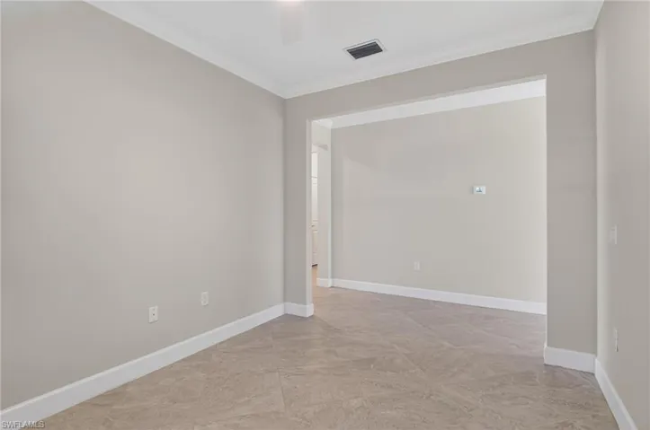 Unfurnished room with baseboards and ornamental molding