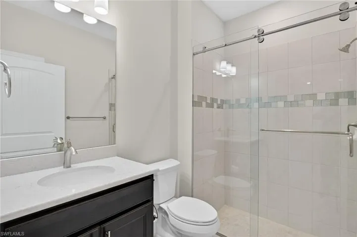 Bathroom with vanity and a stall shower