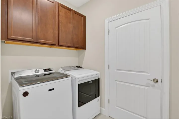 Washroom with cabinet space and separate washer and dryer