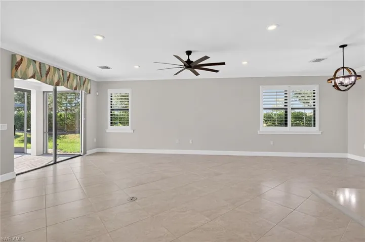 Unfurnished room with ornamental molding, recessed lighting, a ceiling fan, a chandelier, and light tile patterned flooring