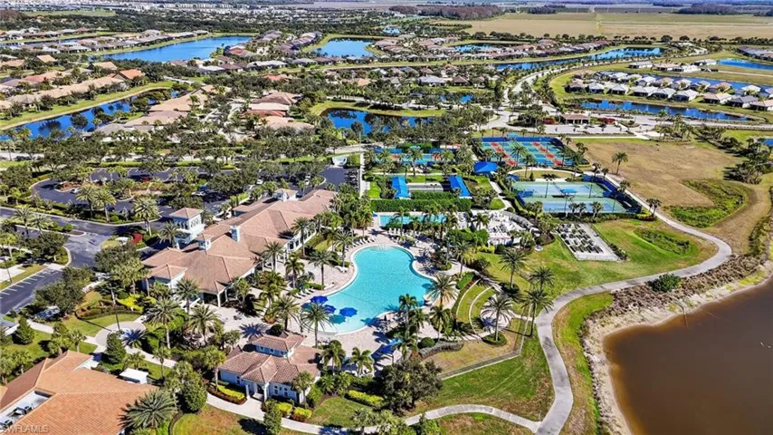 Aerial view of property's location featuring a nearby body of water and nearby suburban area