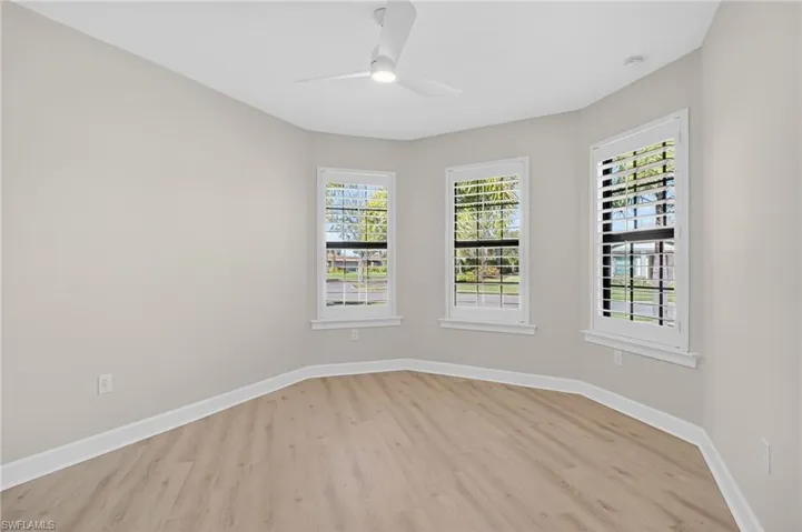 Unfurnished room with light wood finished floors and ceiling fan
