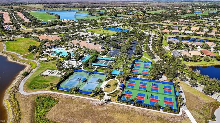 Aerial view of residential area featuring a nearby body of water