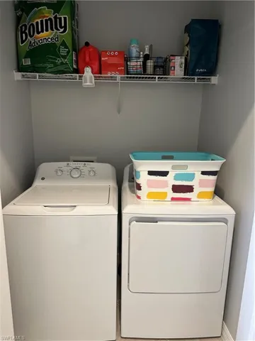 Washroom featuring washing machine and dryer.