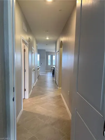 Front door entrance  with light tile patterned flooring
