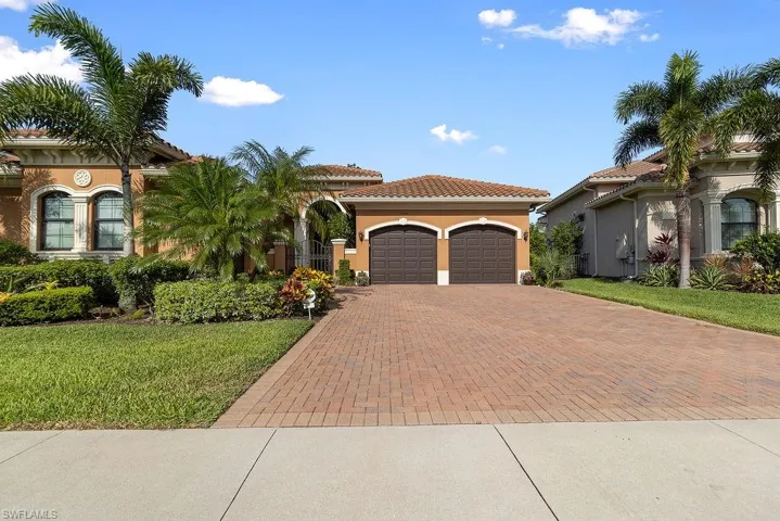 Mediterranean / spanish home featuring a front yard and a garage