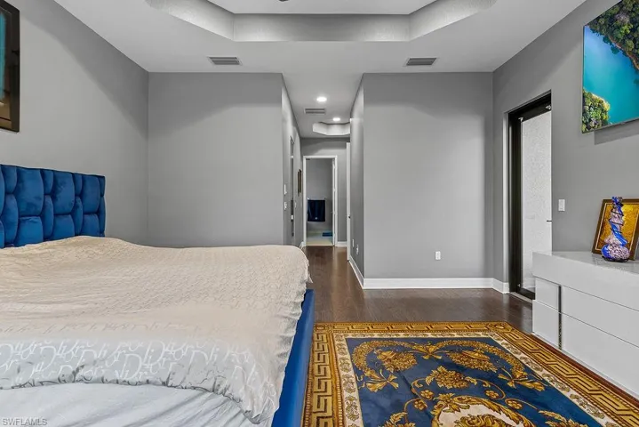 Bedroom with dark wood-type flooring