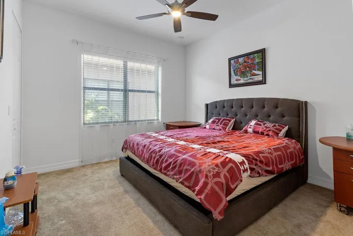 Bedroom featuring light carpet and ceiling fan