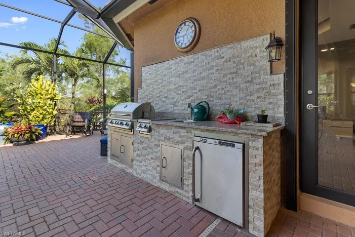 View of patio / terrace featuring a grill, area for grilling, a lanai, and sink