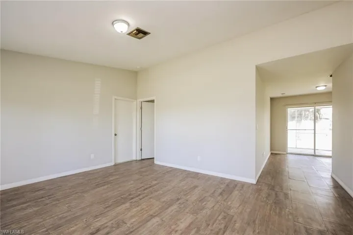 Empty room with hardwood / wood-style flooring