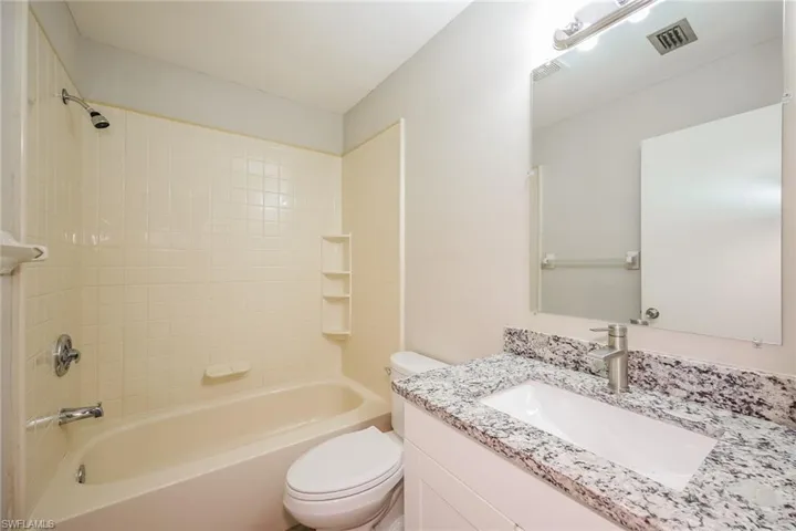 Full bathroom with vanity, toilet, and shower / washtub combination